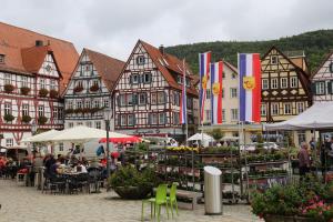 a group of buildings with tables and chairs in a town at Haus Am Sonnenhügel in Bad Urach