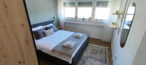 a bedroom with a bed with two towels on it at Apartment 906 in Prishtina in Pristina