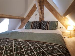 a bedroom with a bed in the attic at Surf Hostel Quiberon, L'Oyat in Saint-Pierre-Quiberon