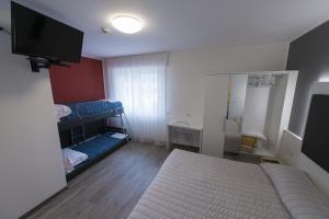 Letto o letti in una camera di Hotel Rolly