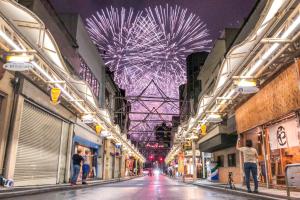 a city street with a large ferris wheel in the background at Guest House MARUYA in Atami