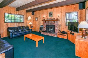 a living room with a couch and a fireplace at Breezy Two-113 by Big Bear Vacations in Big Bear Lake