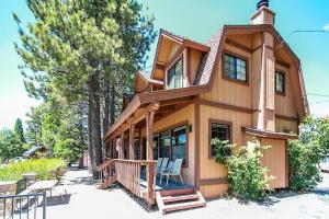a house with two chairs on the porch of it at Breezy Two-113 by Big Bear Vacations in Big Bear Lake