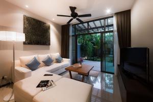 a living room with a white couch and a ceiling fan at Villa Hahana | 3 Bedroom Private Pool Villa in Popular Kokyang Estate | 3 min to Naiharn Beach in Rawai Beach