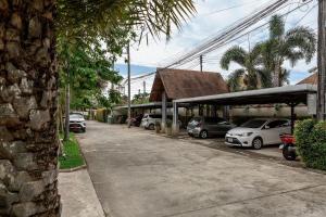 a row of cars parked in a parking lot at Villa Hahana | 3 Bedroom Private Pool Villa in Popular Kokyang Estate | 3 min to Naiharn Beach in Rawai Beach