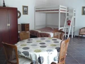a dining room with a table and a bunk bed at Chambres d'Hôtes & Gites Pouget in Les Eyzies-de-Tayac