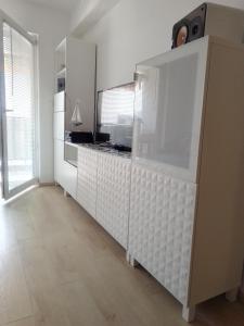 a kitchen with a large white cabinet in a room at Apartman Botivo in Ludbreg