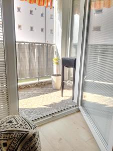 a sliding glass door with a view of a balcony at Apartman Botivo in Ludbreg