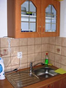 a kitchen counter with a sink and a counter top at Bungalovy Natura in Trávnica