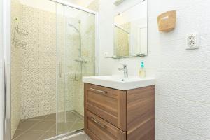 a bathroom with a sink and a shower at Old Market Residence in Šibenik +24 photos