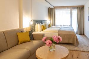 Rúm í herbergi á Gstaaderhof - Active & Relax Hotel