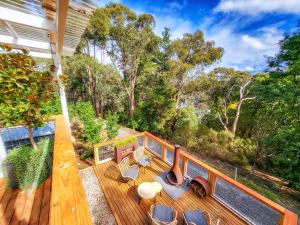 an overhead view of a deck with chairs and trees at Locarno Cottage in Hepburn Springs