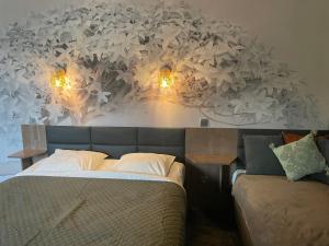 a bedroom with a bed with lights on the wall at Villa Hotel in Troyes +55 photos