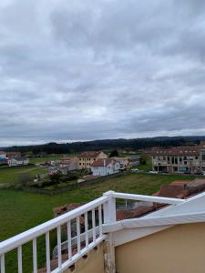 a white balcony with a view of a town at Pension Ameneiral in O Pedrouzo