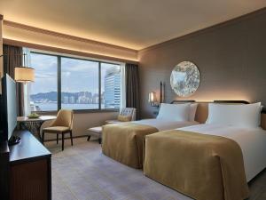 a hotel room with a large bed and a large window at Artyzen Grand Lapa Macau in Macau