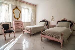 a bedroom with two beds and a dresser and a mirror at A~Mare Casa Vacanze in Fezzano