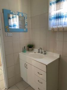 a bathroom with a sink and a mirror at Peter's Port in Pine Point