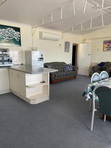 a room with a kitchen and a living room at Peter's Port in Pine Point