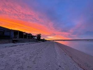a view of a beach with a sunset in the background at Peter's Port in Pine Point