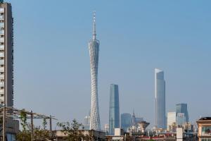 a tall building in the middle of a city at Paco Hotel Canton Tower Pazhou-Shuttel bus for Canton Fair in Guangzhou