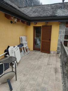 a patio with chairs and a door to a house at Casa Andrea in Cadarese