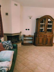 a living room with a couch and a wooden cabinet at Casa Andrea in Cadarese