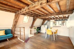 - un salon avec des plafonds en bois, une table et des chaises dans l'établissement The Charming Hendrik Square Apartments, à Anvers 27 autres photos