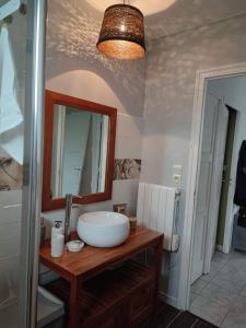 a bathroom with a sink and a mirror at Ty Bihan in Saint-Potan