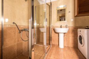 a bathroom with a shower and a sink and a toilet at Xigia Escape villas in Khartáta