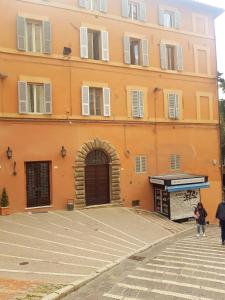 a large orange building with a store in front of it at Il Bijoux in Perugia
