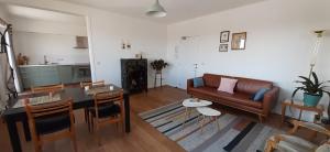 a living room with a couch and a table at De Notelaar in Kortessem +47 photos