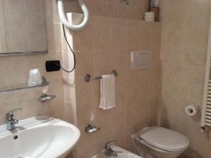 a small bathroom with a sink and a toilet at Hotel Il Saraceno in Volastra