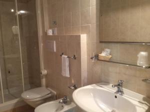 a bathroom with a sink and a toilet and a shower at Hotel Il Saraceno in Volastra +22 photos