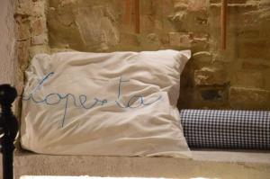 a pillow with the word comfort written on it at Casa Antica in Castiglione dʼOrcia +1 photo