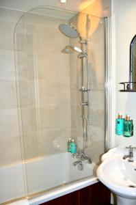 a bathroom with a shower and a sink at The Nest Hotel & Restaurant in Petersfield +26 photos