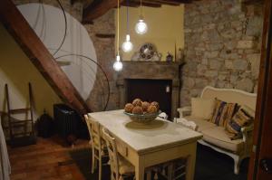 a living room with a table and a couch at Casa Antica in Castiglione dʼOrcia