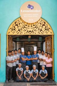 a group of chefs posing for a picture in a doorway at Lemonmint Svelton Manor in Calangute