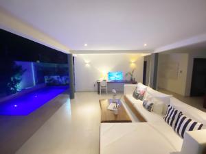 a living room with a white couch and a table at Blanc Residence in Pipa