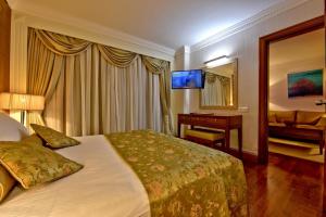 a hotel room with a bed and a desk and a mirror at Side Star Elegance Hotel - All Inclusive in Side