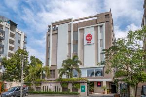 a building with a red sign on the side of it at Spree Hotel Jaipur in Jaipur