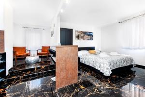 a bedroom with a bed and a living room at Dolce Studio Apartmani in Rovinj +35 photos