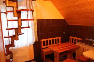 a small kitchen with a wooden table and chairs at Zakochani w Jaworkach in Jaworki