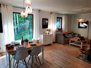 a living room with a table and a couch at Między Brzozami in Pluski