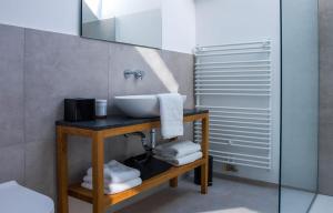 a bathroom with a sink on a table with towels at Hotel Belmur in Murska Sobota