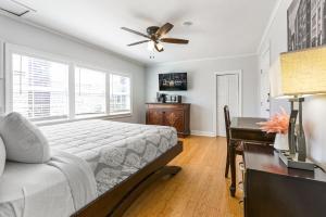a bedroom with a bed and a desk and a ceiling fan at Newly-renovated Comfortable Studios Near All NOLA Hot Spots in New Orleans