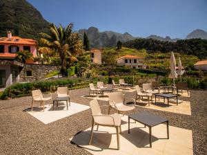 a group of chairs and tables and umbrellas at Solar da Bica in São Vicente