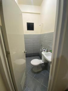 a bathroom with a toilet and a sink at San Jose del monte Bulacan gumaok with aircon unit 1 in Mangangpico +10 photos