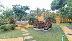 a garden with a cannon in the grass at Rainbow Forest Paradise Resort and Camping Area by Cocotel in Rizal