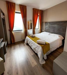 a bedroom with a bed and a large window at Hotel Joli in San Marino