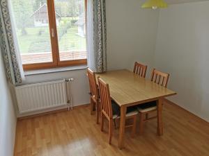 ein Esszimmer mit einem Holztisch und Stühlen in der Unterkunft Apartments Henigman in Bohinj
